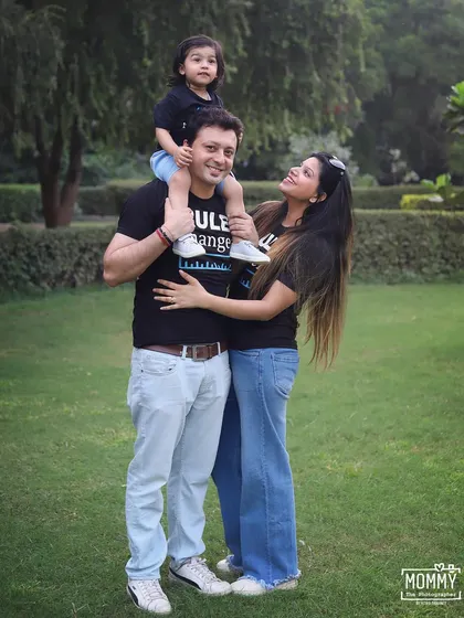 A fun and casual outdoor family portrait. The coordinated black t-shirts and jeans give this photo a cool, modern vibe.