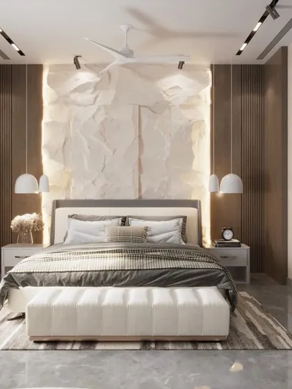 This luxury bedroom is a study in texture and light. A unique, crumpled-paper-effect feature wall is backlit to create a soft glow, while a large abstract artwork adds a bold, modern statement. The result is a classy and artistic personal space.