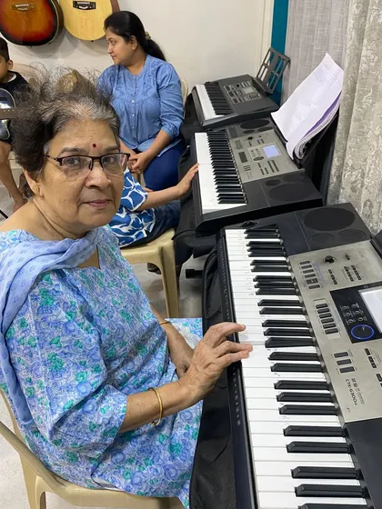 We welcome students of all ages, and it's a joy to see everyone discover their passion for music. This student is in one of our keyboard classes, proving that it's never too late to start learning a new skill.