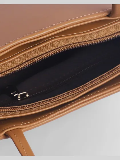 An interior shot of a women's handbag, revealing the lining, pockets, and zipper details. This is crucial for helping customers assess functionality.