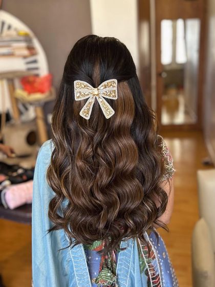 This angle shows how the bow hairstyle looks with a dupatta. The accessory remains a beautiful focal point, adding a modern twist to the traditional look.