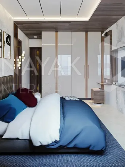 A full view of this modern bedroom highlights the integrated design. The glossy white wardrobe with a built-in vanity, the tufted headboard, and the wood-paneled ceiling come together to create a space that is both open and intimate.