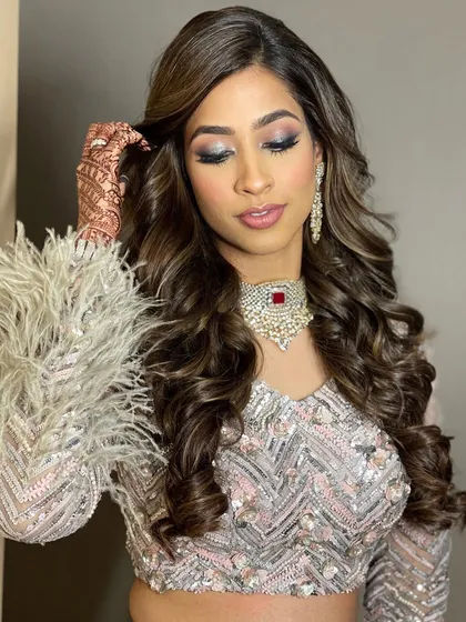 A close-up of the sangeet glam look, showing the texture and movement in the hair.