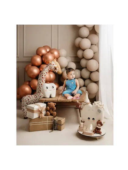 A unique and fun tooth-themed birthday setup. This is a great way to celebrate a first birthday, especially for little ones who have just gotten their first teeth.