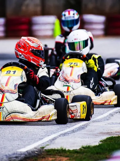 Our drivers in their white and orange liveried karts, racing closely together.