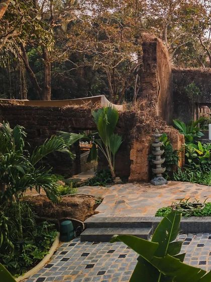 The weathered stone ruins at Sanctuary Bar, which form the backbone of the landscape design. The space is designed to feel like a hidden discovery, blending history with nature.