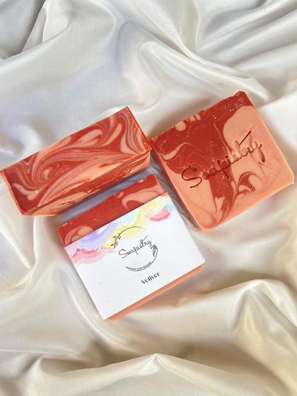 This Vetiver soap features a beautiful red and white swirl. It's made with skin-loving oils and butters for a nourishing lather.