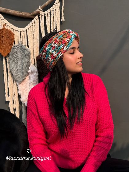 Modeling one of our twisted crochet headbands. The design is not only stylish but also provides a snug and comfortable fit, keeping you warm without messing up your hair.