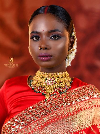 A close-up portrait that captures the fierce elegance of a South Indian bride. The focus on the eyes and the bold red bindi makes for a powerful and memorable image.