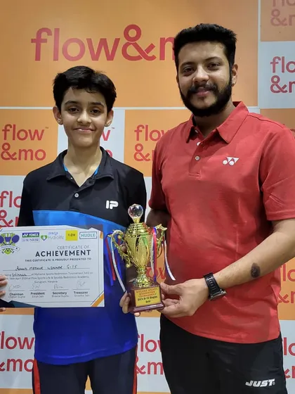 Hard work pays off. Here I am with one of my dedicated students after his win at the 'My Game Open Badminton Tournament'. This is the result of consistent effort and disciplined training.
