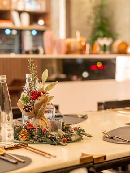 An elegantly set table with a festive centerpiece for our Christmas celebration. We create a magical ambiance to make your holiday dining experience truly special.