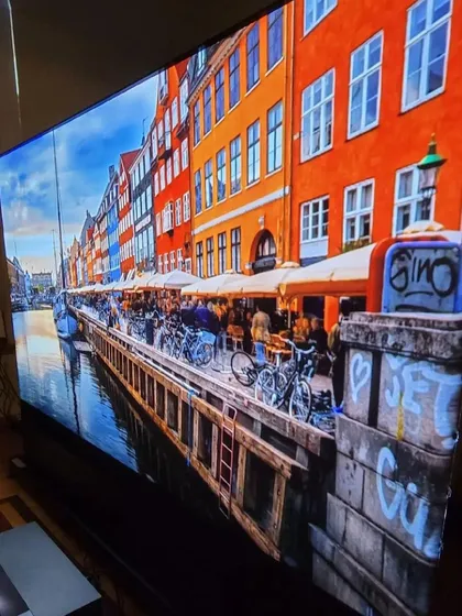 For living rooms and brighter spaces, we install ultra-short-throw (UST) projectors paired with ambient light rejecting (ALR) screens. This setup delivers a massive, vibrant 4K picture with excellent contrast and color, even without having to turn off all the lights.