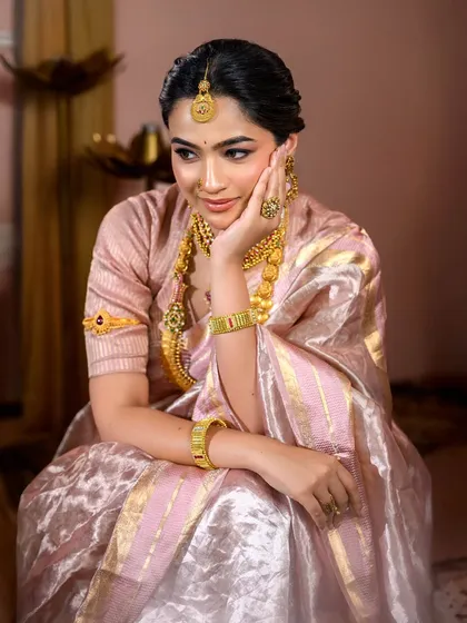 A candid moment from our traditional photoshoot. The makeup is soft and glowing, designed to look perfect both on camera and in person.