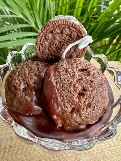 Another angle of the chocolate ice cream sundae candle, showing the realistic texture of the ice cream scoops and the dripping chocolate sauce, all made from soy wax.