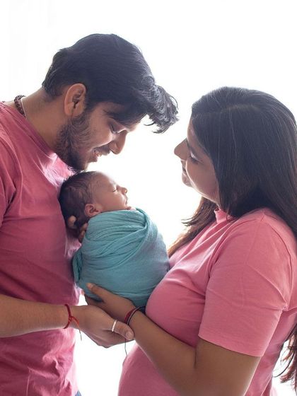 A beautiful candid moment from a newborn session. The way the parents look at their baby is full of so much love and adoration.