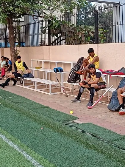 Players taking a break on the sidelines. Rest and recovery are just as important as the intense drills.