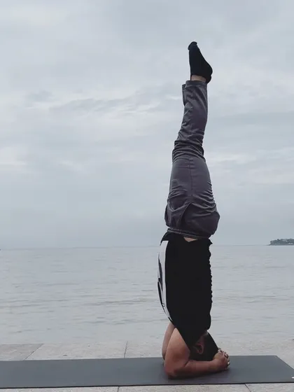 Sirsasana (Headstand) against the backdrop of the ocean. Inversions shift your perspective, both literally and figuratively.