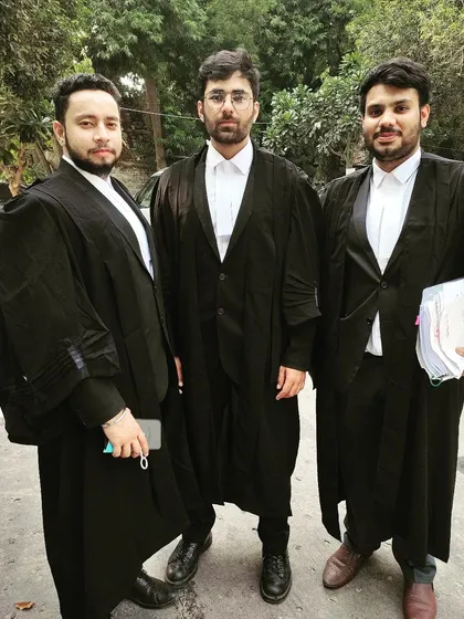Dressed in our advocate robes, ready for a formal court appearance. This attire signifies our role and responsibility in the courtroom.
