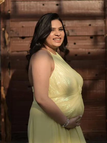 A happy, candid moment from a maternity shoot. The makeup is all about a soft base, peach blush, and subtle shimmer on the eyes to enhance her already glowing charm.