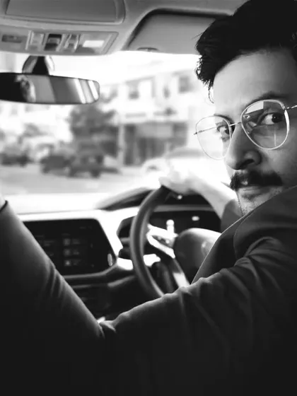 Another perspective from the in-car series with Ali Fazal. The focus on his reflection in the rearview mirror adds an artistic layer to this black and white celebrity portrait.