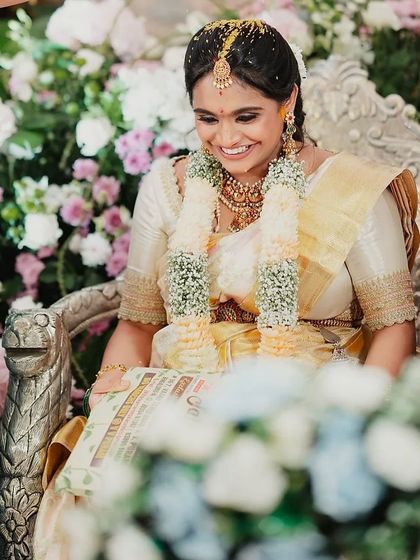 A joyful, candid moment from a client's baby shower. She is glowing in an off-white Kanchivaram saree and a custom hand-embroidered blouse I designed for her.