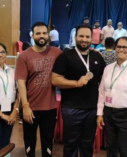 A moment with officials and a fellow medalist at the Dasara CM Cup. The respect and sportsmanship in the weightlifting community are unmatched.