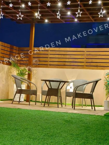 We created a charming dining nook under a wooden pergola, complete with star-shaped string lights for a magical touch. The space is set on a lush artificial lawn, making it perfect for evening meals.