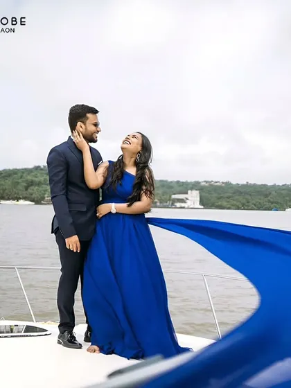 Create a dramatic pre-wedding moment with this royal blue trail gown. The flowing fabric against the water makes for a breathtaking shot.