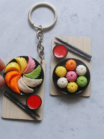 A pair of momo miniatures, one with colorful wrappers and the other classic white.