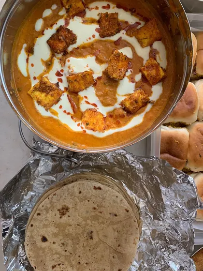 Creamy Paneer Tikka Masala served alongside soft pav and phulkas.