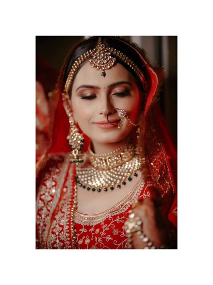 A stunning close-up of Vaishali, her eyes closed, highlighting her flawless makeup and the intricate details of her jewelry.