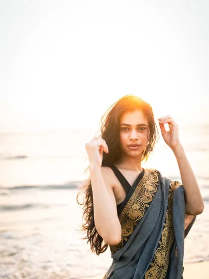 The sun flare in this shot adds a dreamy, artistic quality. It’s a technique I use to enhance the magical feel of a sunset beach shoot.