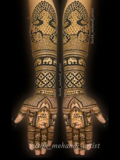 A complete bridal mehandi with the couple's names, Taru and Yuvraj, written on the wrists. The design is filled with peacocks and elephants.