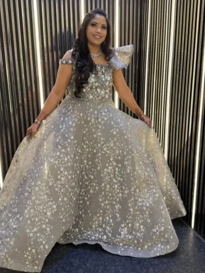 This client is glowing in a silver-grey ball gown with all-over sequin work. It’s a fairytale dress, perfect for a reception or engagement party.