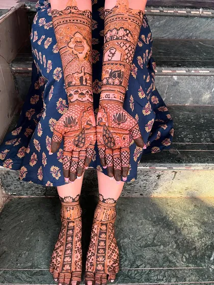 A complete bridal look, with coordinated designs for the hands and feet. The lotus and elephant motifs are carried through both, creating a cohesive and stunning effect.