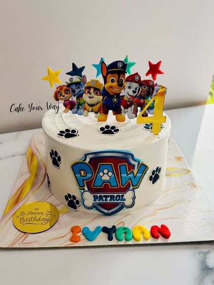 A paw-some Paw Patrol cake for a 4th birthday, featuring the whole team ready for action.