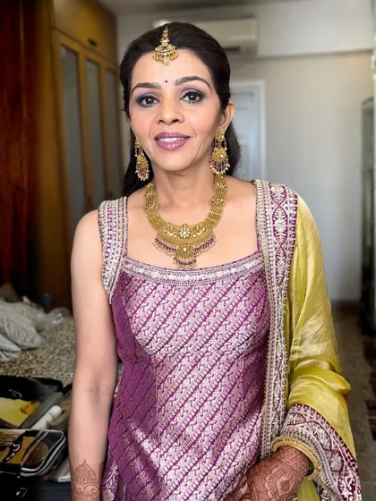 This look for a wedding guest is both soft and timeless. I used a palette of purples on the eyes to match her beautiful brocade outfit, keeping the skin fresh and the lips in a complementary mauve shade.