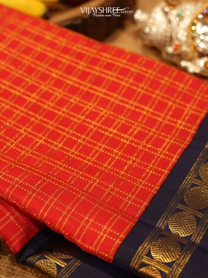 A red Kanjivaram featuring a rare Bentex border, known for its jewel-like finish that mimics temple jewelry.
