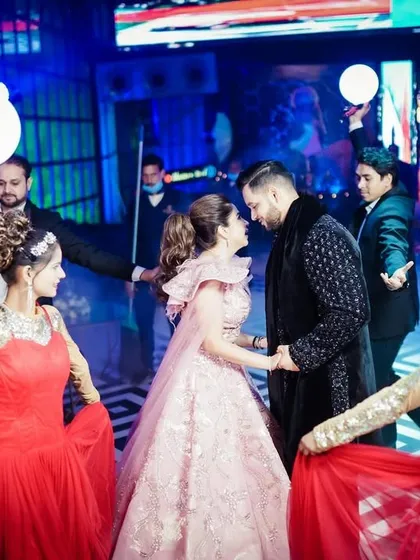 The couple's grand entrance at their cocktail party, complete with professional dancers and dramatic lighting, creating a truly spectacular moment.