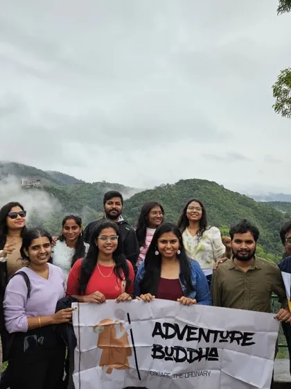Proudly flying the Adventure Buddha banner against the misty hills of Coorg. We are a community of explorers.