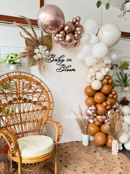 Celebrating a 'Baby in Bloom' with this chic, bohemian-themed baby shower. I used a warm, earthy palette of neutral and rose gold balloons, accented with dried pampas grass. The wicker peacock chair creates a beautiful focal point for the mom-to-be.