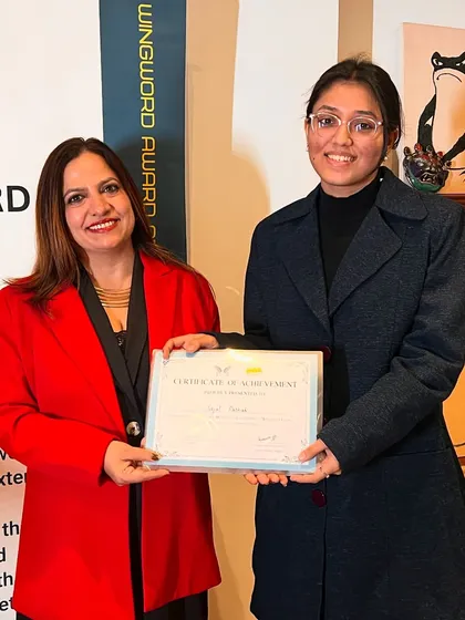 A poet proudly holds her certificate at the award ceremony.