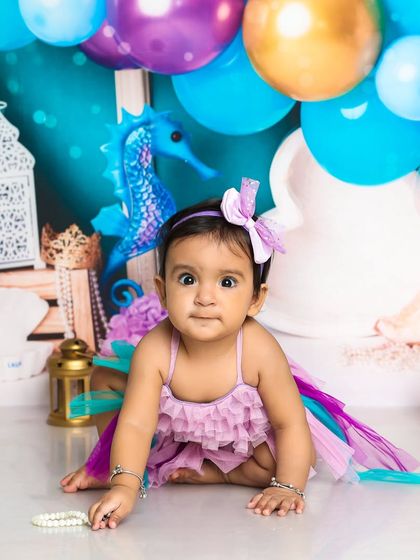 A curious look from our little mermaid. The wide-eyed expression is absolutely captivating in this under-the-sea themed portrait.