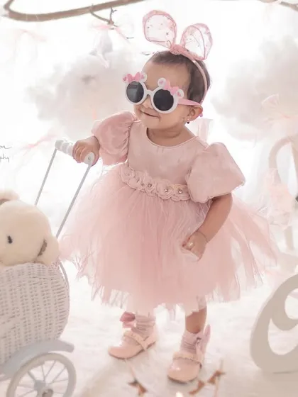 Celebrating a first birthday with style and a bit of fun. This portrait shows your child's budding personality, set against a dreamy, cloud-like backdrop that I designed to make the moment magical.