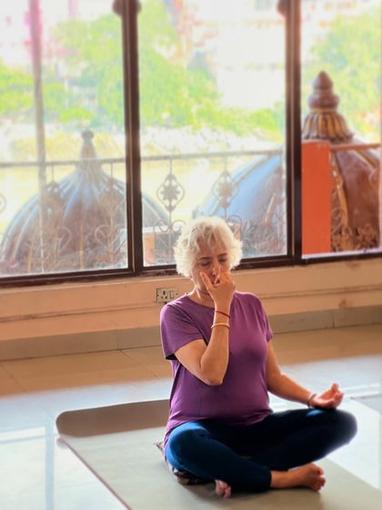 An older student practices pranayama. For seniors, these breathing exercises are a boon for increasing vitality, reducing stiffness, and promoting overall wellbeing.