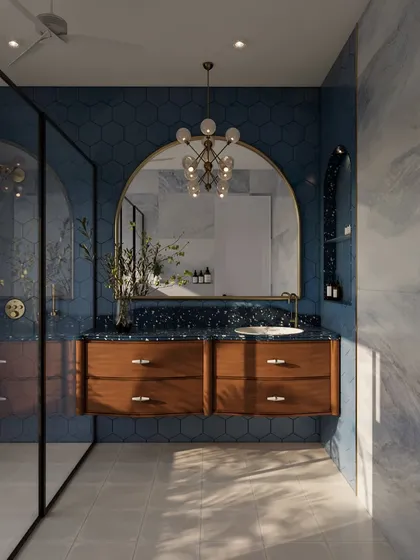 This bathroom makes a bold statement with its deep blue hexagonal tiles and a terrazzo-style countertop. The large arched mirror and modern globe chandelier add a layer of glamour and sophistication.