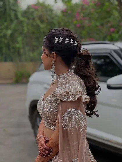 A side profile of the modern Sangeet hairstyle, showing how the delicate accessories complete the look.