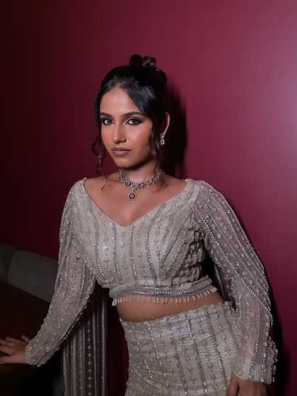 A full-body shot that shows how the makeup, hair, and outfit come together to create a cohesive and stunning cocktail look.