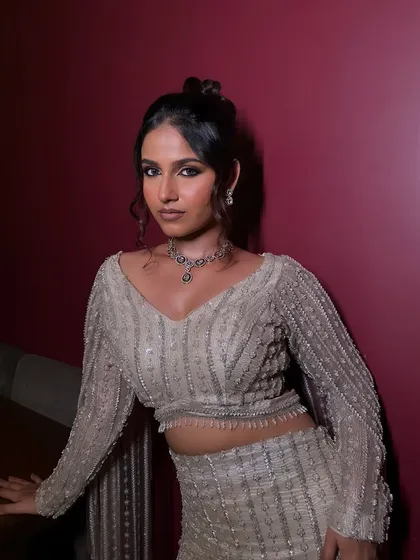 A full-body shot that shows how the makeup, hair, and outfit come together to create a cohesive and stunning cocktail look.