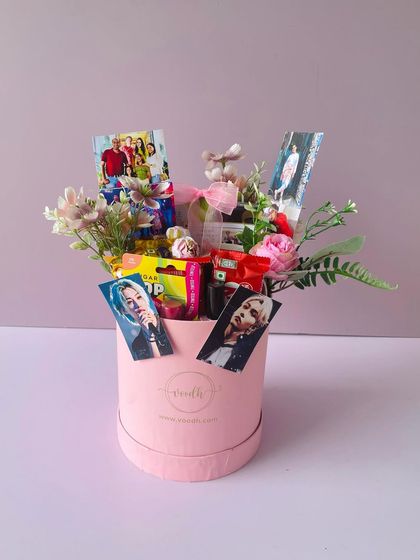 Another angle of the personalized birthday hamper, showing the floral arrangement and the custom photo sticks.